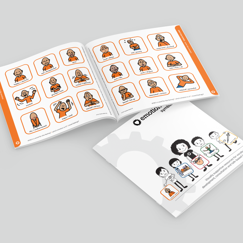 A square printed booklet showing cartoon illustrations of people in orange robes, with a second folded sheet placed in front. The pages have orange borders and small text, photographed on a light grey background.