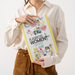 A person holds a book titled 'KAIROS WOMEN Spring Programme 2024-2026'. The book cover features a white background with a yellow border and colorful illustrations of women.